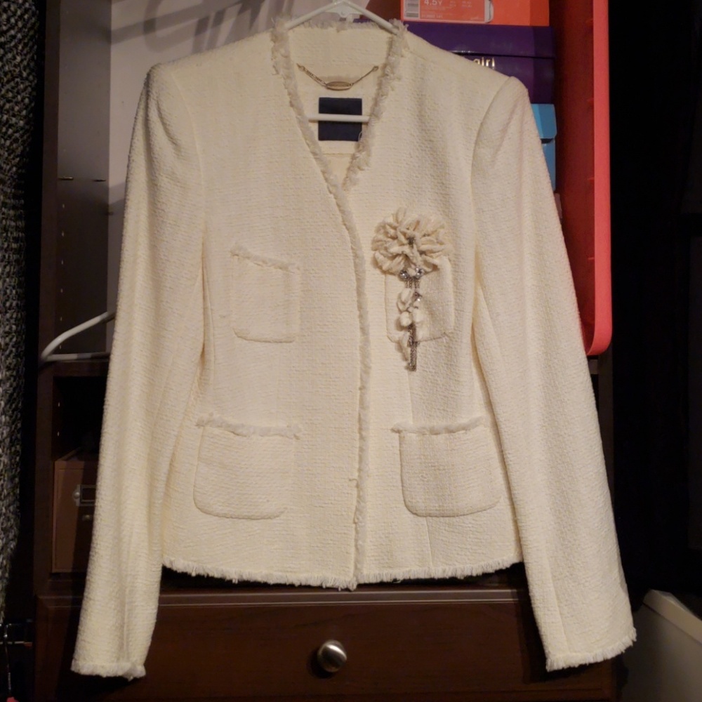 White tweed jacket with flower pin